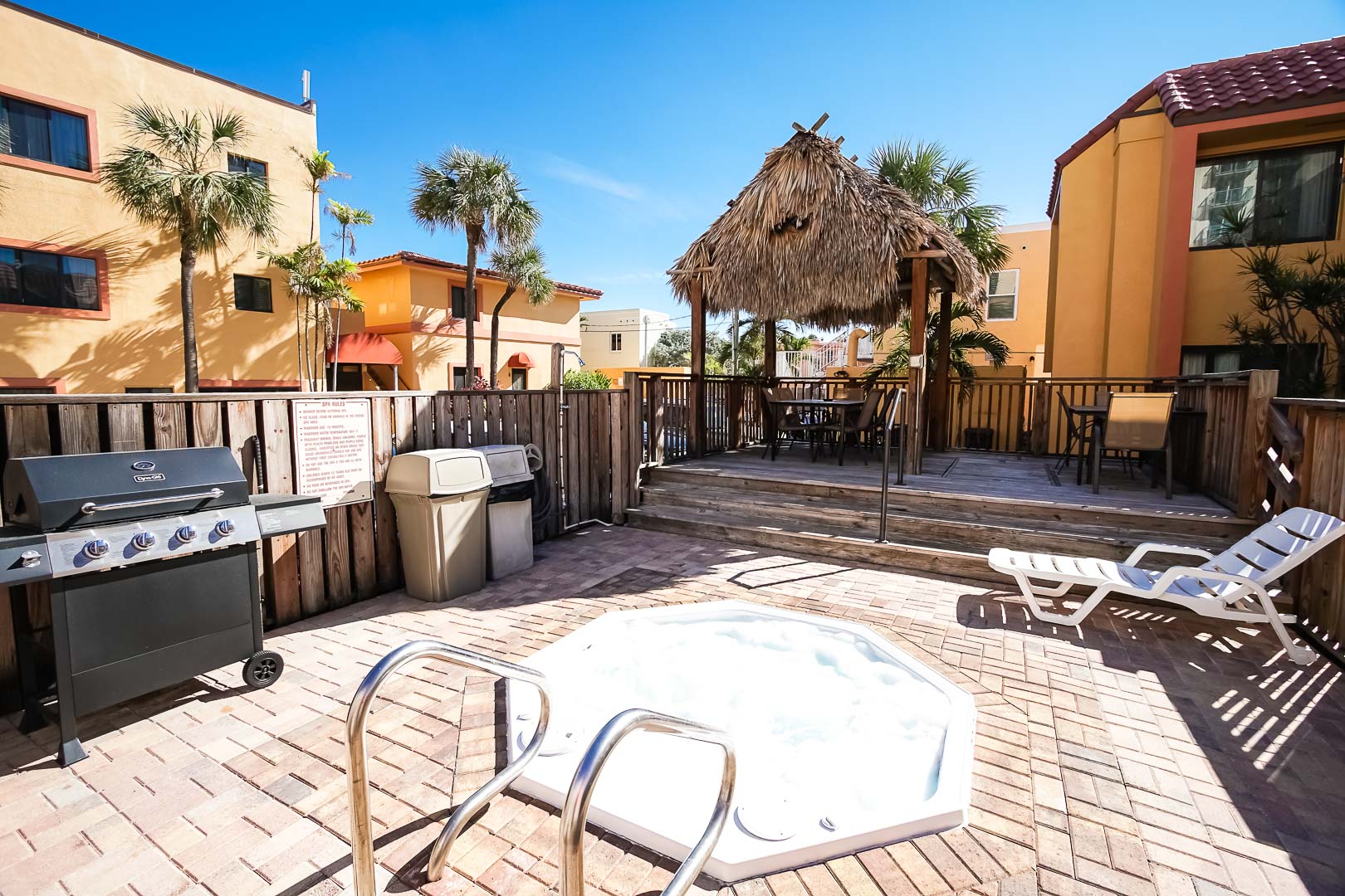 An outdoor Jacuzzi tub and BBQ Grills at VRI's Hollywood Sands Resort in Hollywood, Florida.
